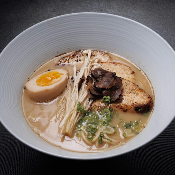 Aja Asian Cuisine's ramen bowl with pork, egg, enoki mushrooms, and green onions.